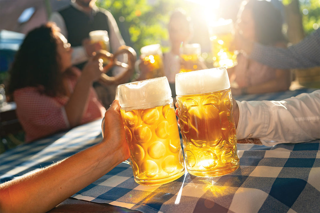 the Reinheitsgebot, Germans Beer purity Law. People cheering with 2 glasses of bavarian beer